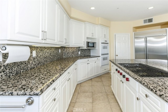24736 Wooded Vis, West Hills, CA 91307 - kitchen featuring stainless steel appliances, stone counters, white cabinets, decorative backsplash, and recessed lighting
