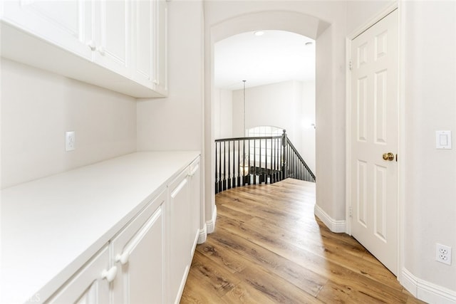 24736 Wooded Vis, West Hills, CA 91307 - hall with light wood finished floors, an upstairs landing, and arched walkways