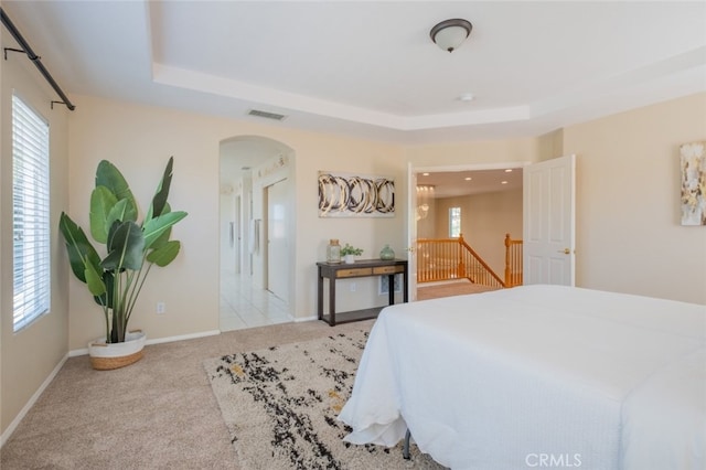 4892 Borders St, Simi Valley, CA 93063 - carpeted bedroom featuring arched walkways, a raised ceiling, and multiple windows