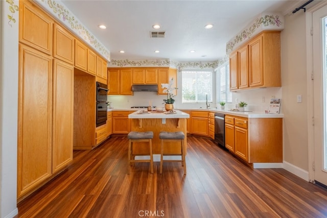 4892 Borders St, Simi Valley, CA 93063 - kitchen with dishwashing machine, under cabinet range hood, dark wood-style floors, light countertops, and recessed lighting