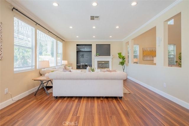 4892 Borders St, Simi Valley, CA 93063 - living area featuring ornamental molding, wood finished floors, healthy amount of natural light, recessed lighting, and a glass covered fireplace