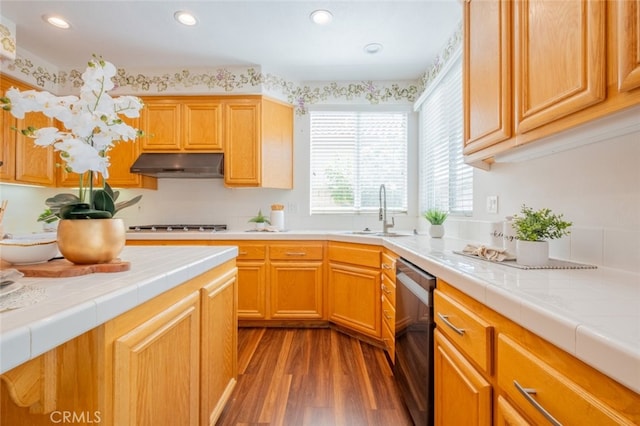 4892 Borders St, Simi Valley, CA 93063 - kitchen featuring under cabinet range hood, dishwashing machine, dark wood-style floors, tile countertops, and recessed lighting