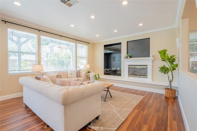 4892 Borders St, Simi Valley, CA 93063 - living area with crown molding, recessed lighting, wood finished floors, and a glass covered fireplace
