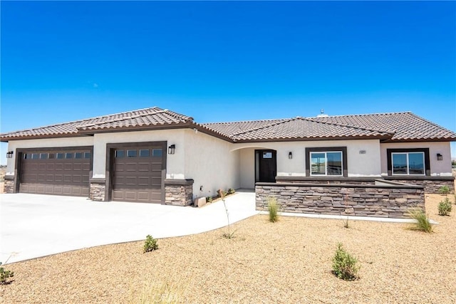 15323 Turquoise Rd, Apple Valley, CA 92307 - view of front of home featuring stone siding, stucco siding, an attached garage, a tile roof, and concrete driveway