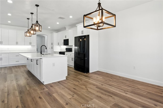15323 Turquoise Rd, Apple Valley, CA 92307 - kitchen featuring black appliances, a chandelier, recessed lighting, arched walkways, and white cabinets