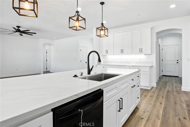 15323 Turquoise Rd, Apple Valley, CA 92307 - kitchen with arched walkways, dishwasher, light stone counters, a ceiling fan, and recessed lighting
