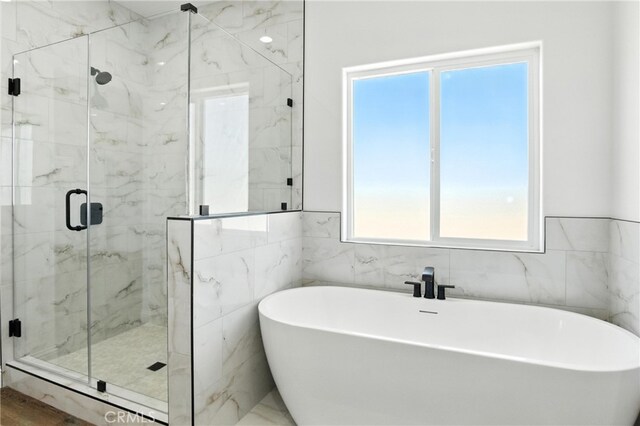15323 Turquoise Rd, Apple Valley, CA 92307 - bathroom with a marble finish shower, tile walls, and a freestanding tub