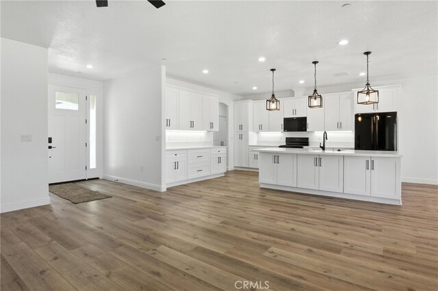 15323 Turquoise Rd, Apple Valley, CA 92307 - kitchen featuring black appliances, recessed lighting, white cabinets, light wood-style flooring, and light countertops