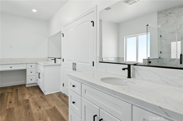 15323 Turquoise Rd, Apple Valley, CA 92307 - full bathroom with a marble finish shower, vanity, wood finished floors, and recessed lighting