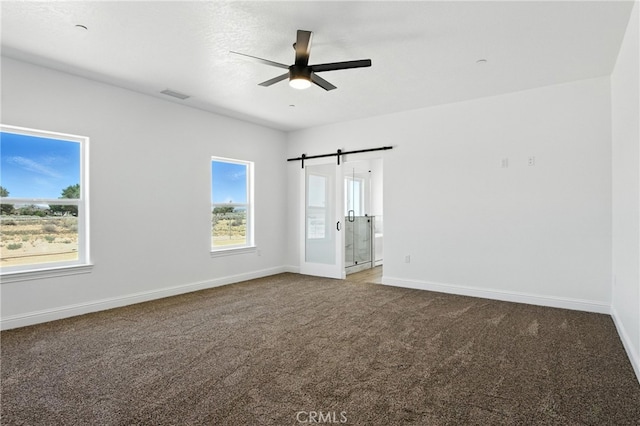 15323 Turquoise Rd, Apple Valley, CA 92307 - unfurnished bedroom with carpet floors, multiple windows, and a barn door