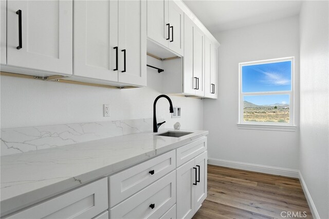 15323 Turquoise Rd, Apple Valley, CA 92307 - kitchen featuring white cabinetry, wood finished floors, light stone counters, and a mountain view