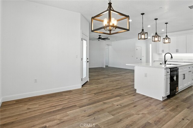 15323 Turquoise Rd, Apple Valley, CA 92307 - kitchen featuring black dishwasher, a chandelier, white cabinets, wood finished floors, and a ceiling fan