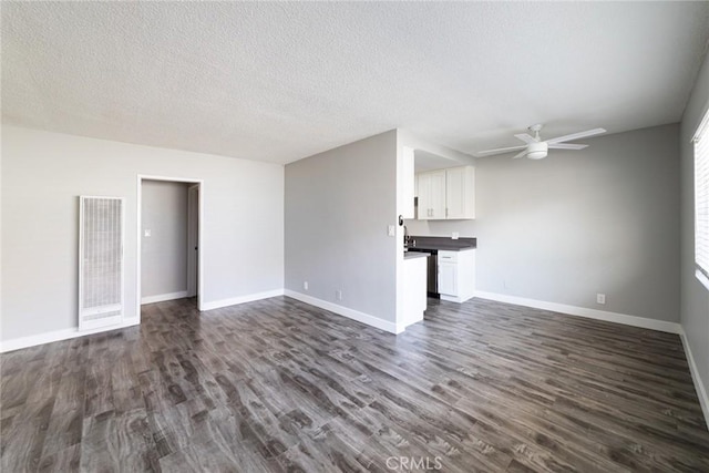 1106 Pacific Ave, Long Beach, CA 90813 - unfurnished living room with a heating unit, ceiling fan, dark wood finished floors, and a textured ceiling