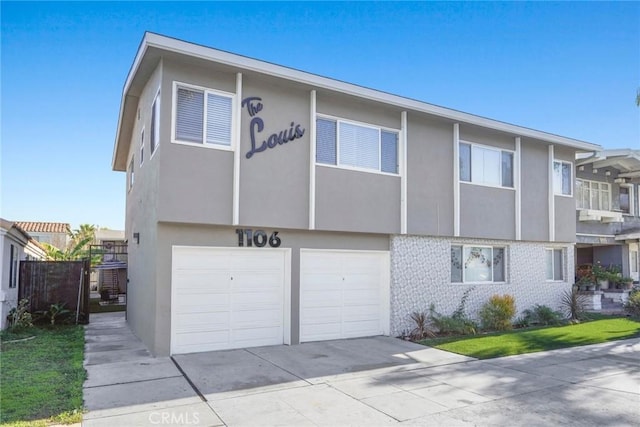 1106 Pacific Ave, Long Beach, CA 90813 - townhome / multi-family property featuring driveway, stucco siding, an attached garage, and brick siding