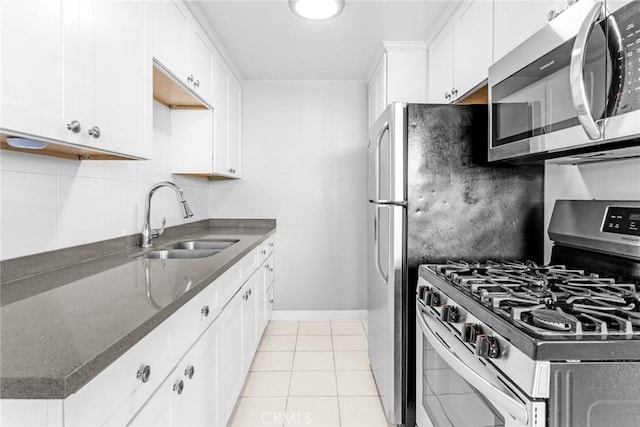 1106 Pacific Ave, Long Beach, CA 90813 - kitchen featuring stainless steel appliances, dark stone counters, white cabinets, and light tile patterned flooring