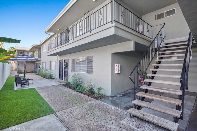 1106 Pacific Ave, Long Beach, CA 90813 - back of property featuring stairway, a patio area, and stucco siding