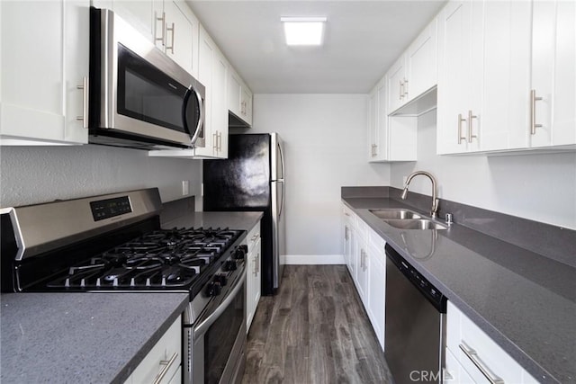 1106 Pacific Ave, Long Beach, CA 90813 - kitchen with appliances with stainless steel finishes, dark wood finished floors, white cabinetry, and dark stone countertops