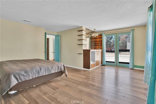 7165 Lyons Ave, Hesperia, CA 92345 - bedroom featuring access to outside, wood finished floors, a textured ceiling, and french doors