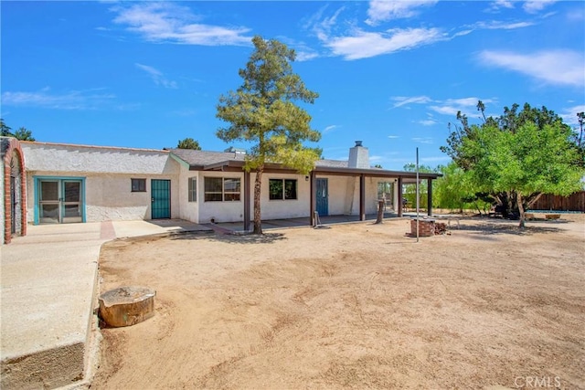 7165 Lyons Ave, Hesperia, CA 92345 - back of house featuring stucco siding and a chimney