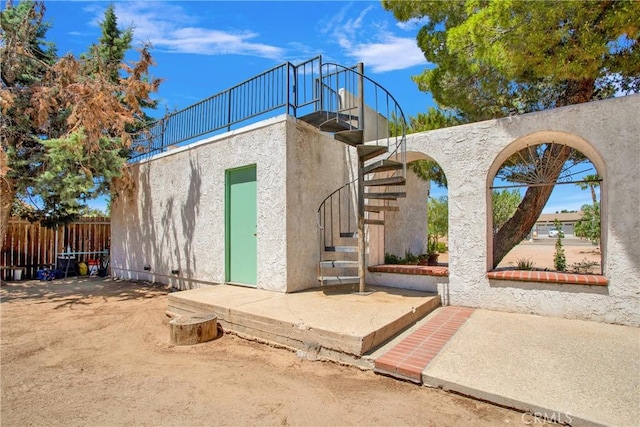 7165 Lyons Ave, Hesperia, CA 92345 - back of house featuring stairway and stucco siding