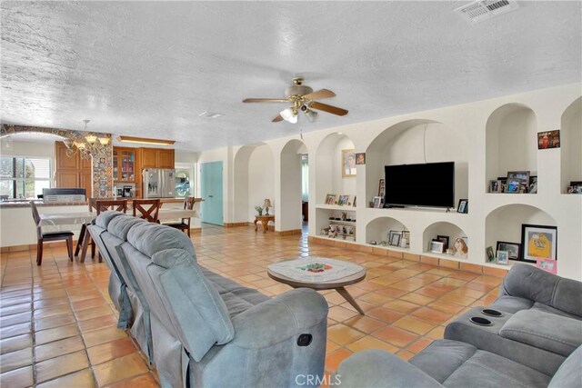 7165 Lyons Ave, Hesperia, CA 92345 - living area featuring light tile patterned flooring, a chandelier, built in features, a ceiling fan, and a textured ceiling