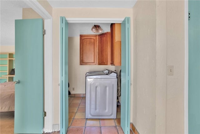 7165 Lyons Ave, Hesperia, CA 92345 - laundry area with cabinet space, washer and dryer, and light tile patterned floors