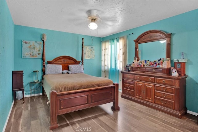 7165 Lyons Ave, Hesperia, CA 92345 - bedroom with light wood-type flooring, a textured ceiling, and ceiling fan