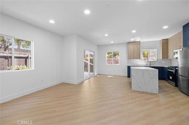 542 N Keystone St, Burbank, CA 91506 - kitchen featuring appliances with stainless steel finishes, a kitchen island, recessed lighting, light wood-type flooring, and tasteful backsplash