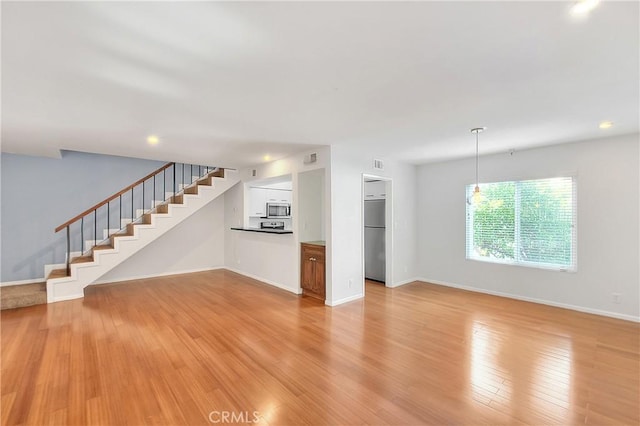 11154 Huston St Unit 7, North Hollywood, CA 91601 - unfurnished living room featuring stairway, light wood-style floors, and recessed lighting