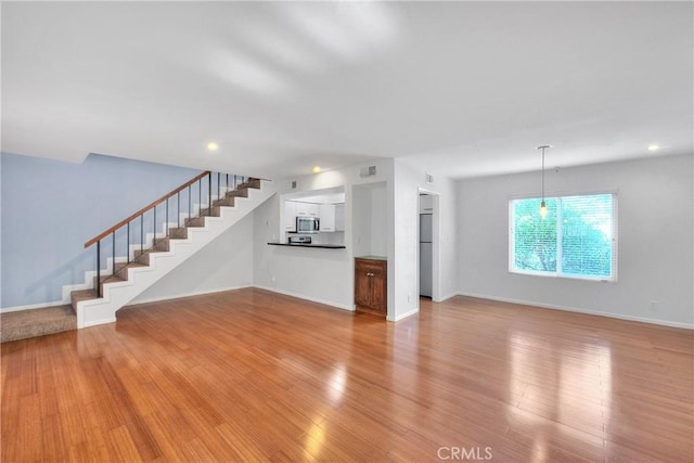 11154 Huston St Unit 7, North Hollywood, CA 91601 - unfurnished living room featuring stairs, light wood finished floors, and recessed lighting