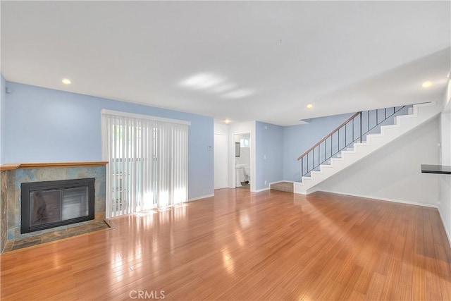 11154 Huston St Unit 7, North Hollywood, CA 91601 - unfurnished living room featuring stairway, a tiled fireplace, wood finished floors, and recessed lighting