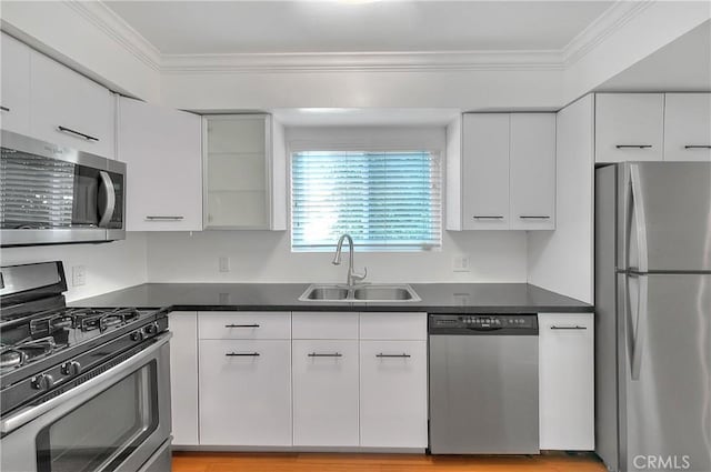 11154 Huston St Unit 7, North Hollywood, CA 91601 - kitchen with appliances with stainless steel finishes, ornamental molding, dark countertops, white cabinets, and glass insert cabinets