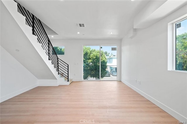 5836 Ernest Ave, Los Angeles, CA 90034 - unfurnished living room with light wood-type flooring, recessed lighting, and stairway