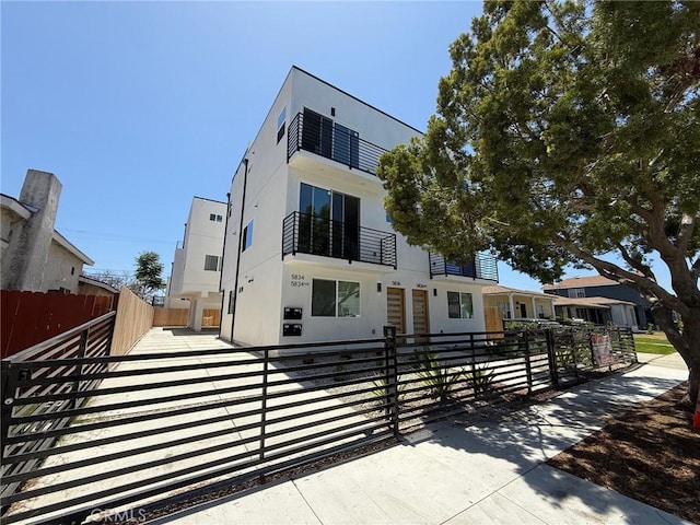 5836 Ernest Ave, Los Angeles, CA 90034 - contemporary home with a fenced front yard, stucco siding, and a gate