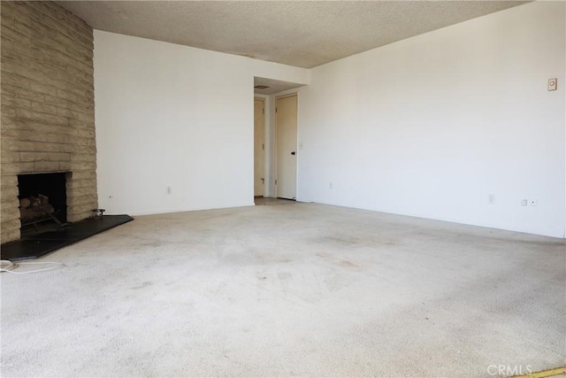 1754 N Kenmore Ave Unit 201, Los Angeles, CA 90027 - unfurnished living room featuring carpet, a fireplace, and a textured ceiling