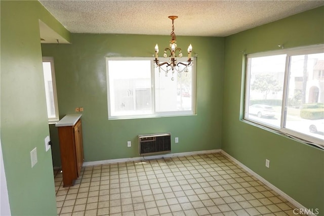 1754 N Kenmore Ave Unit 201, Los Angeles, CA 90027 - unfurnished dining area with a chandelier, a wall mounted air conditioner, and a textured ceiling