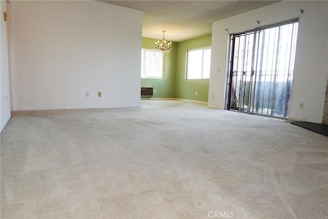 1754 N Kenmore Ave Unit 201, Los Angeles, CA 90027 - carpeted empty room with a chandelier and a textured ceiling