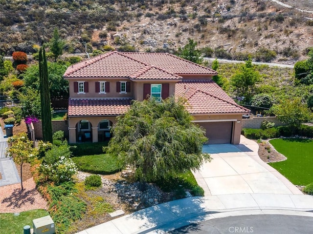 17122 Broken Rock Ct, Riverside, CA 92503 - mediterranean / spanish house with stucco siding, a tiled roof, concrete driveway, and a garage