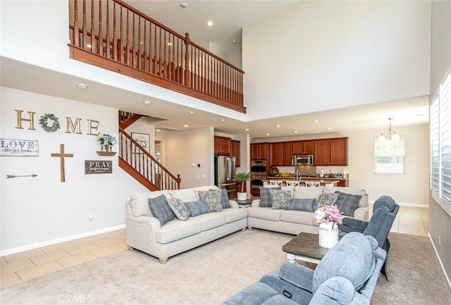 17122 Broken Rock Ct, Riverside, CA 92503 - living area featuring a towering ceiling, light tile patterned floors, recessed lighting, stairs, and a chandelier