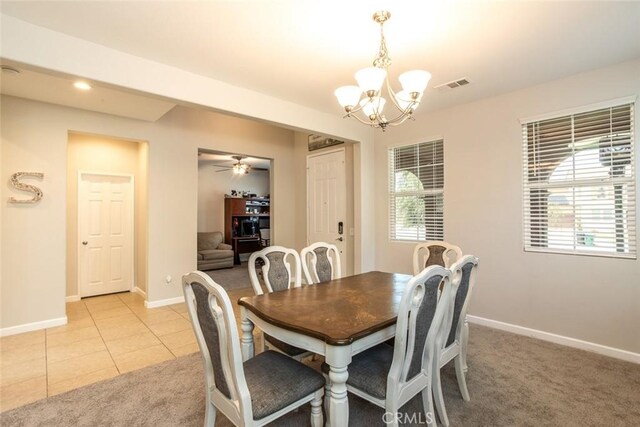 17122 Broken Rock Ct, Riverside, CA 92503 - dining room with a chandelier, light colored carpet, a ceiling fan, and light tile patterned floors