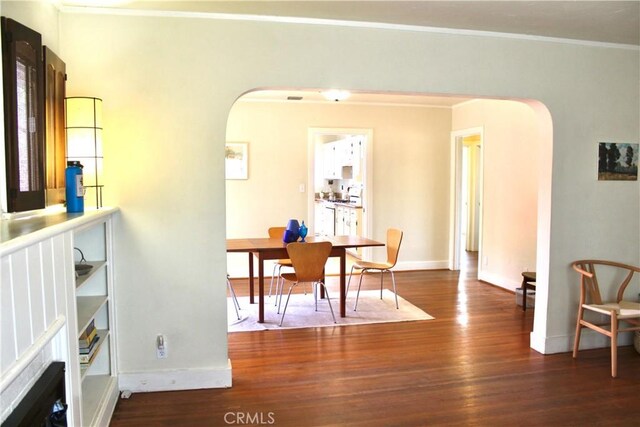 907 E Poppyfields Dr E, Altadena, CA 91001 - dining space with arched walkways, wood finished floors, and crown molding