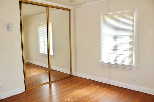 907 E Poppyfields Dr E, Altadena, CA 91001 - unfurnished bedroom featuring crown molding, wood finished floors, and a closet