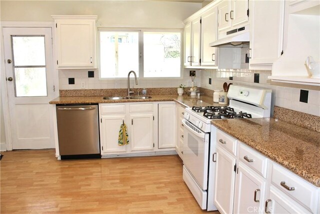 907 E Poppyfields Dr E, Altadena, CA 91001 - kitchen with stainless steel dishwasher, white gas stove, ventilation hood, white cabinetry, and decorative backsplash