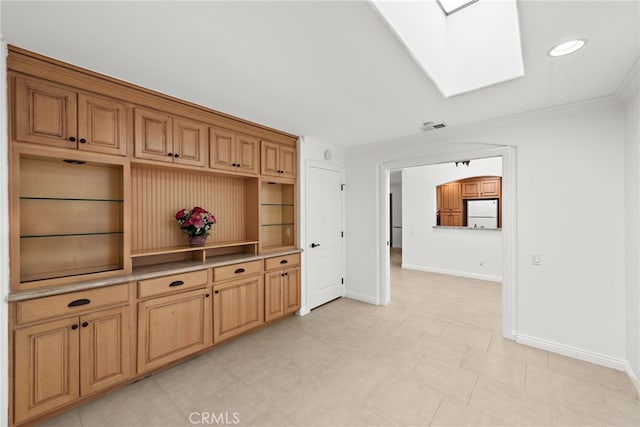 456 Avenida Seville Unit C, Laguna Woods, CA 92637 - unfurnished living room featuring a skylight and ornamental molding