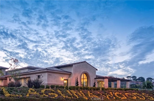 456 Avenida Seville Unit C, Laguna Woods, CA 92637 - view of front of property with a tile roof, stucco siding, and an attached garage