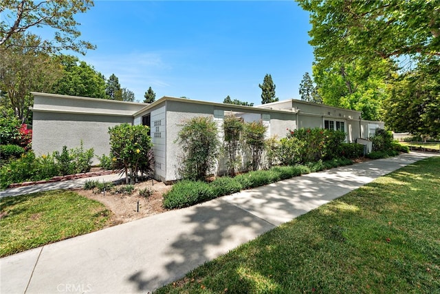 456 Avenida Seville Unit C, Laguna Woods, CA 92637 - view of property exterior with a yard