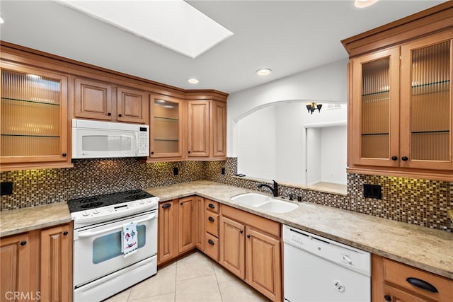 456 Avenida Seville Unit C, Laguna Woods, CA 92637 - kitchen with white appliances, light tile patterned floors, backsplash, recessed lighting, and glass insert cabinets