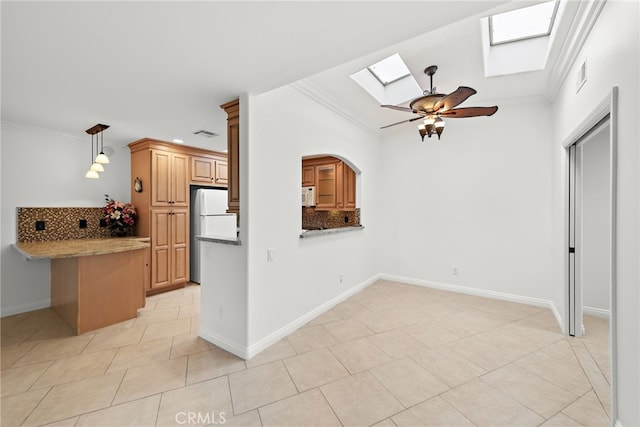456 Avenida Seville Unit C, Laguna Woods, CA 92637 - kitchen featuring a skylight, white appliances, ornamental molding, backsplash, and ceiling fan