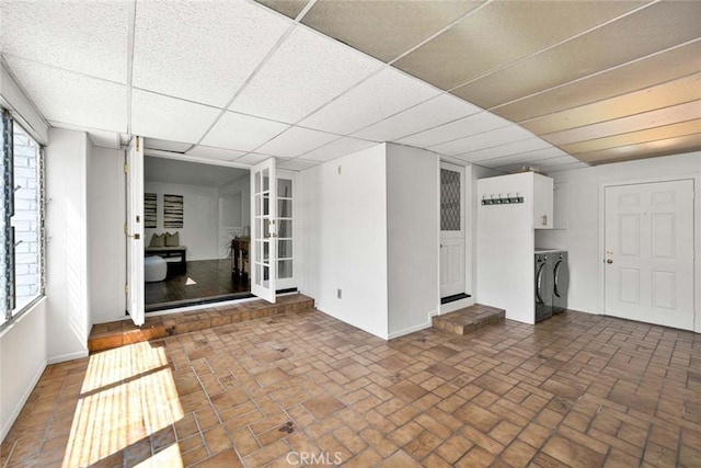 1428 E Adams Ave, Orange, CA 92867 - unfurnished living room featuring washer and dryer and brick patterned floors