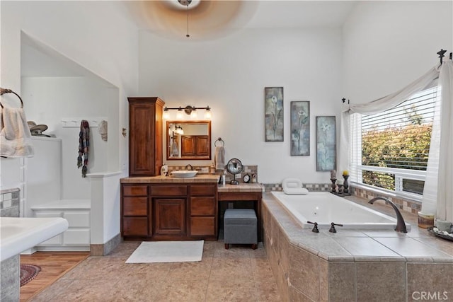 23220 Lakeview Dr, Tehachapi, CA 93561 - bathroom with a towering ceiling, a jetted tub, vanity, and tile patterned flooring
